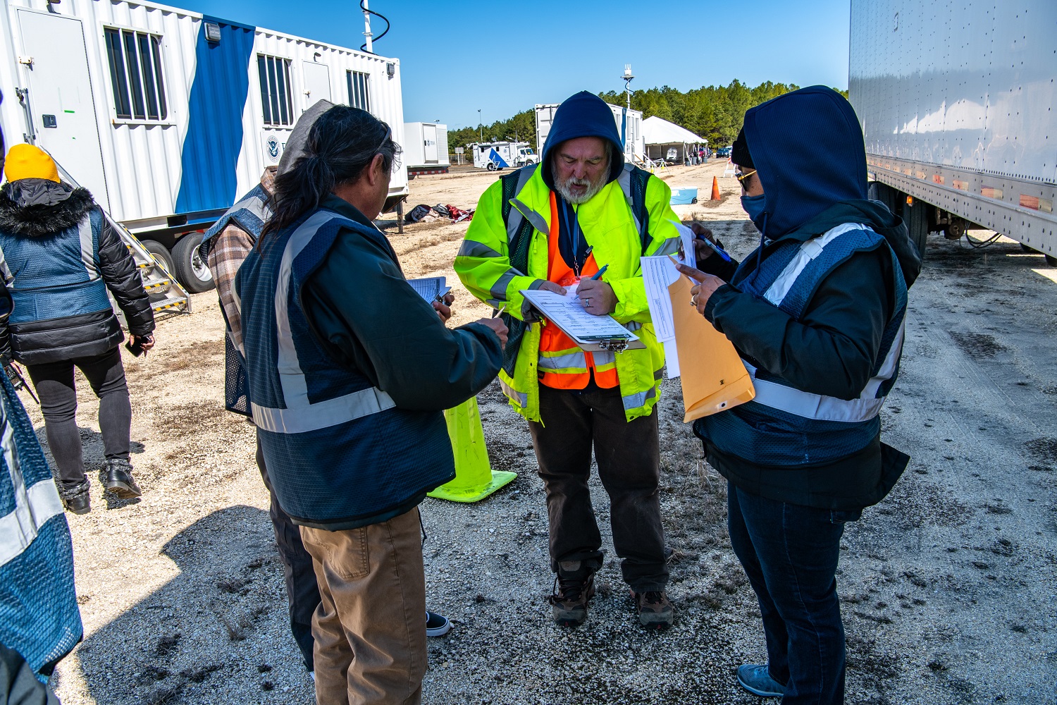 Employees in FEMA safety vests on a cold day