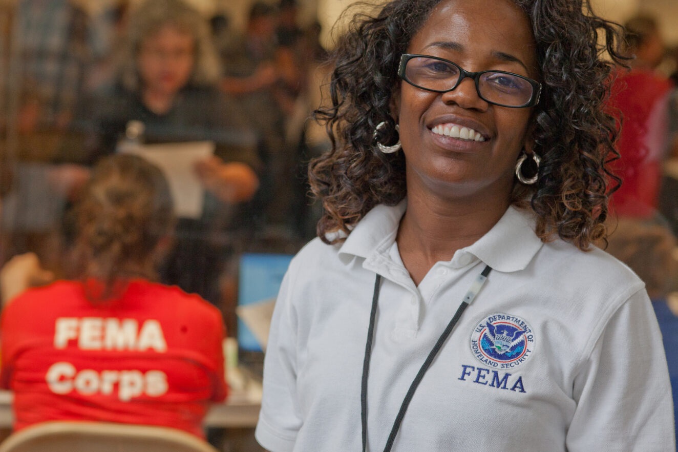 Smiling woman in a FEMA polo shirt