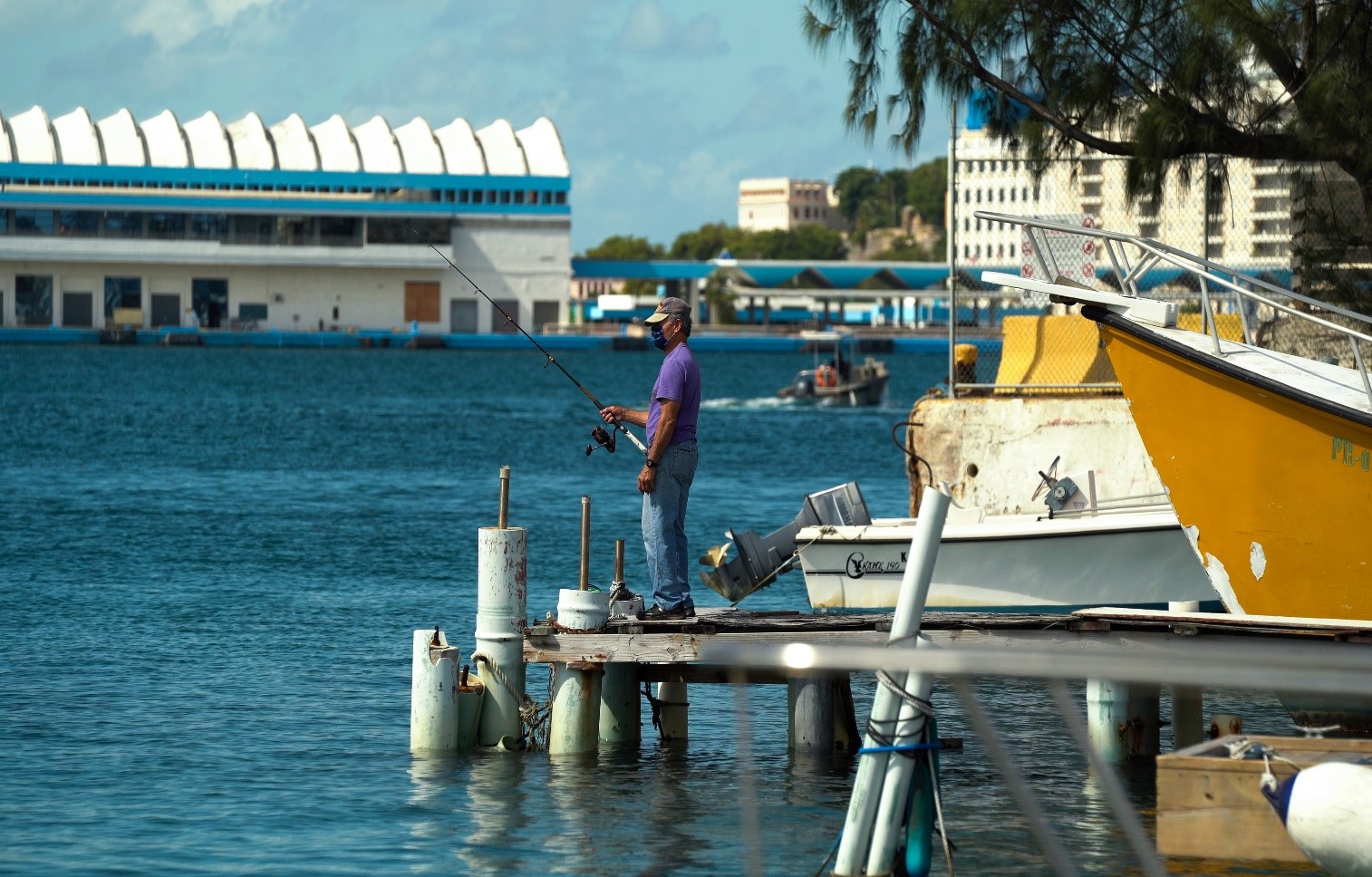 A man fishing on the dock in San Juan