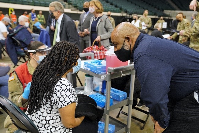 Acting FEMA Region 5 Regional Administrator checks in with vaccine recipients at the Cleveland community vaccination center.