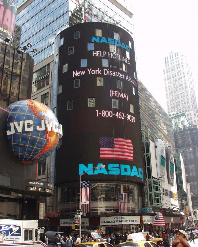 NASDAQ building's banner displaying FEMA New York Disaster Assistance help line phone number